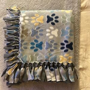 50x60” fleece tie blanket.  Paw print pattern fleece with gray fleece backing